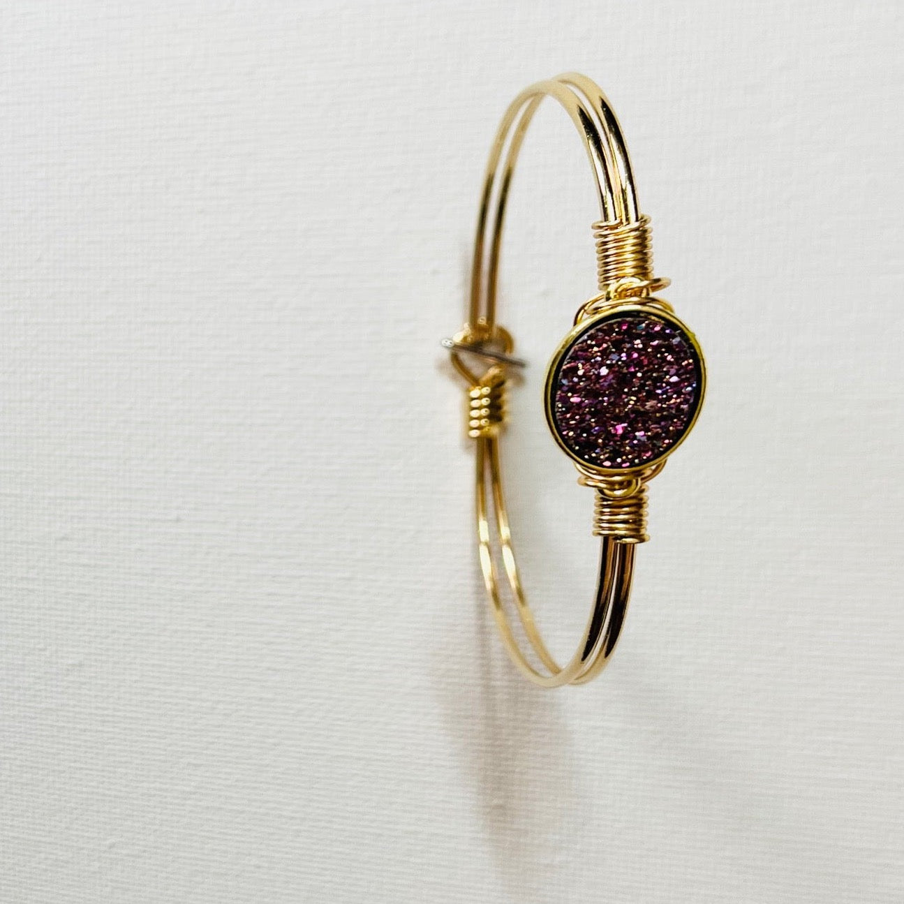 Gem Stone Look Charm Bracelet Plated 22k Gold or Platinum with Gem Stone Look Charm Hand Wired to Bracelets. Colors Hot Pink, Pink, Green, Metallic Purple, and Silver. Choice of Bracelets Plated 22 Gold or Platinum .